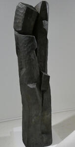 Roughly columnar black stone sculplture.