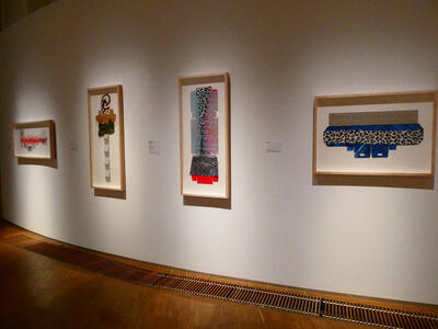 Wall with four abstract paintings.