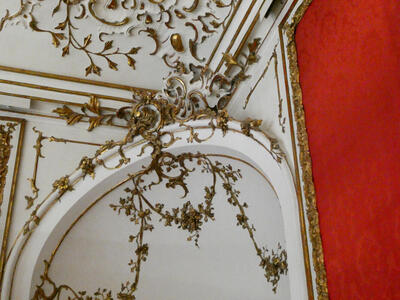 Closeup of gold leaves-and-branches on ceiling