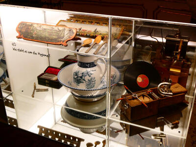 At left, old delft blue pitcher in a bowl; at right, a record and some old machinery