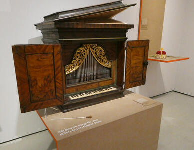 Small cabinet with a piano-like keyboard