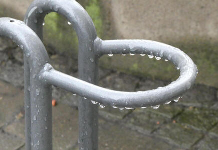 Water droplets on a bicycle rack
