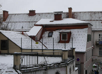 Roof of old building with snow on it.
