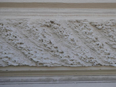 Brickwork carved in a way that somewhat resembles sea foam.