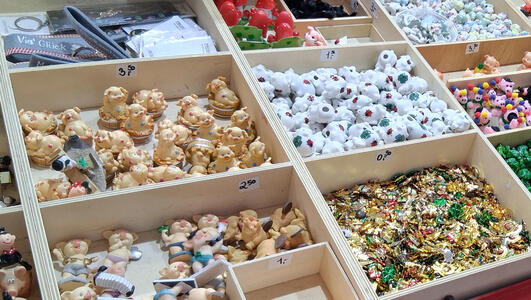 Closeup of trays with small ceramic toys in them.