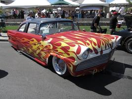 Red classic car painted with yellow flames