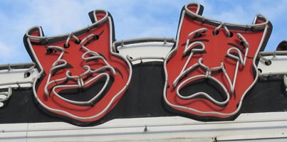 Comedy/Tragedy masks with neon lighting