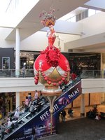 Christmas ornament with showgirl as top; red clothing and bulb
