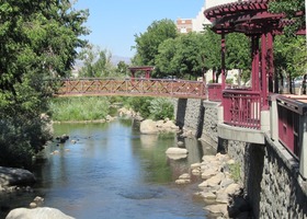 Long view with purple fence at right, wooden bridge in center