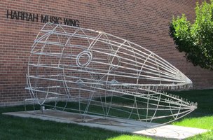 large head of fish (possibly a shark) made of wire