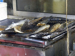 Fish grilling outside restaurant