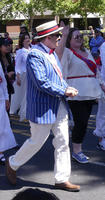 Man in blue pinstripe jacket and straw hat