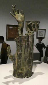 sculpture of hand with bird sitting on finger