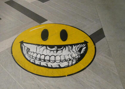 smiley face with human teeth