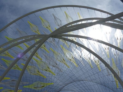 Wire and plastic sculpture outside convention center; sun reflecting off plastic