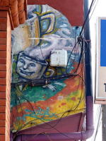 Wall painting of coffee cup with a face