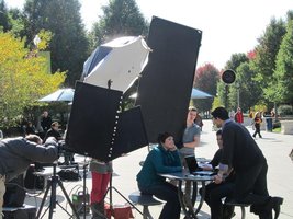 Photographers with screens and cameras, shooting an advertisement