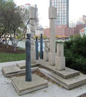 Human-like sculptures among vertical spiral-shaped sculptures
