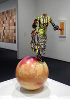 headless woman standing on globe