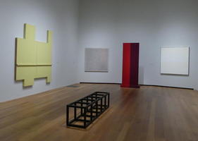 Long view gallery with geometrical sculpture and paintings