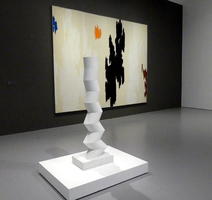 Angled paper-like tube in front of abstract painting