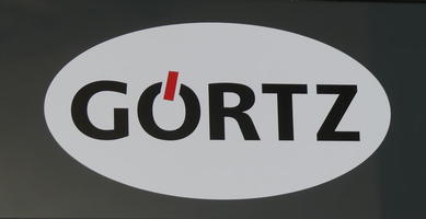 Sign with an angled line through the top of a letter “O” to symbolize an umlaut