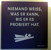 Sign with superhero silhouette at bottom.