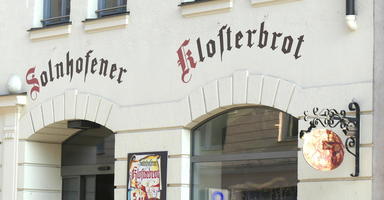 Lettering above arched windows