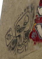 Graffiti of person saying “Love” in word balloon