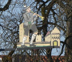 Man in lederhosen playing a trumpet