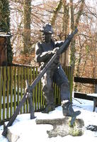 Sculpture of man using some farming implement