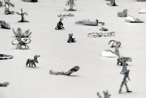 Various aluminum foil sculptures including carrot, person, bear, and deer