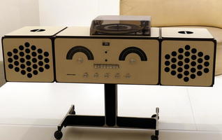 Old stereo system with controls arranged to look a bit like a human face.