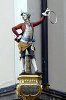 Statue of man in red jacket and breeches
