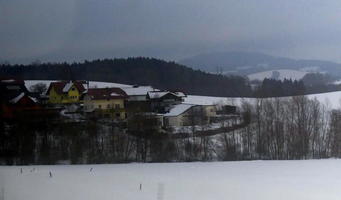 Snow-covered village in middle distance