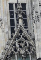 Closeup of church showing three-leafed circular design in carving
