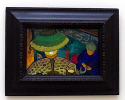 Woman sitting at table with lamp with green lampsahde