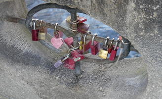 Padlocks (some heart shaped) on a bridge