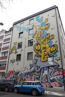 Wall art with speakers and musical notes on five-story building