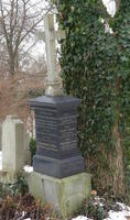 Grave marker being pushed over by tree growth