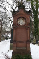Brown grave marker from 1870s with large cameo of man
