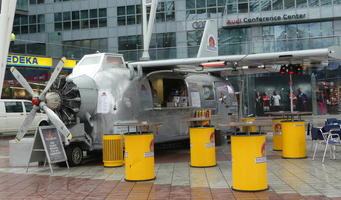 Currywurst restaurant buit into an RV with airplane wings and propeller