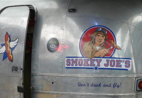 Logo on side of restaurant; aviator holding sausage on fork