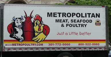 Cow, lobster, and rooster in group hug