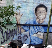 Young man in blue shirt holding book
