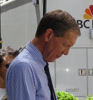 Fox News reporter looking down at his text
