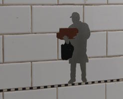 Silhouette of panhandler on subway wall