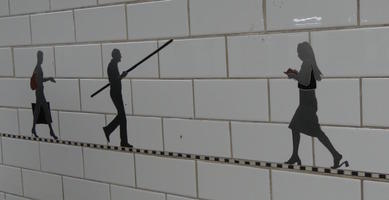 Silhouettes of subway riders