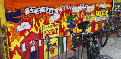 Brightly painted advert on front of burger restaurant
