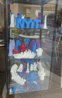 Case of 3-d sculptures; top shelf has large NYIT